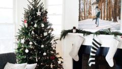 living room with christmas tree and stockings